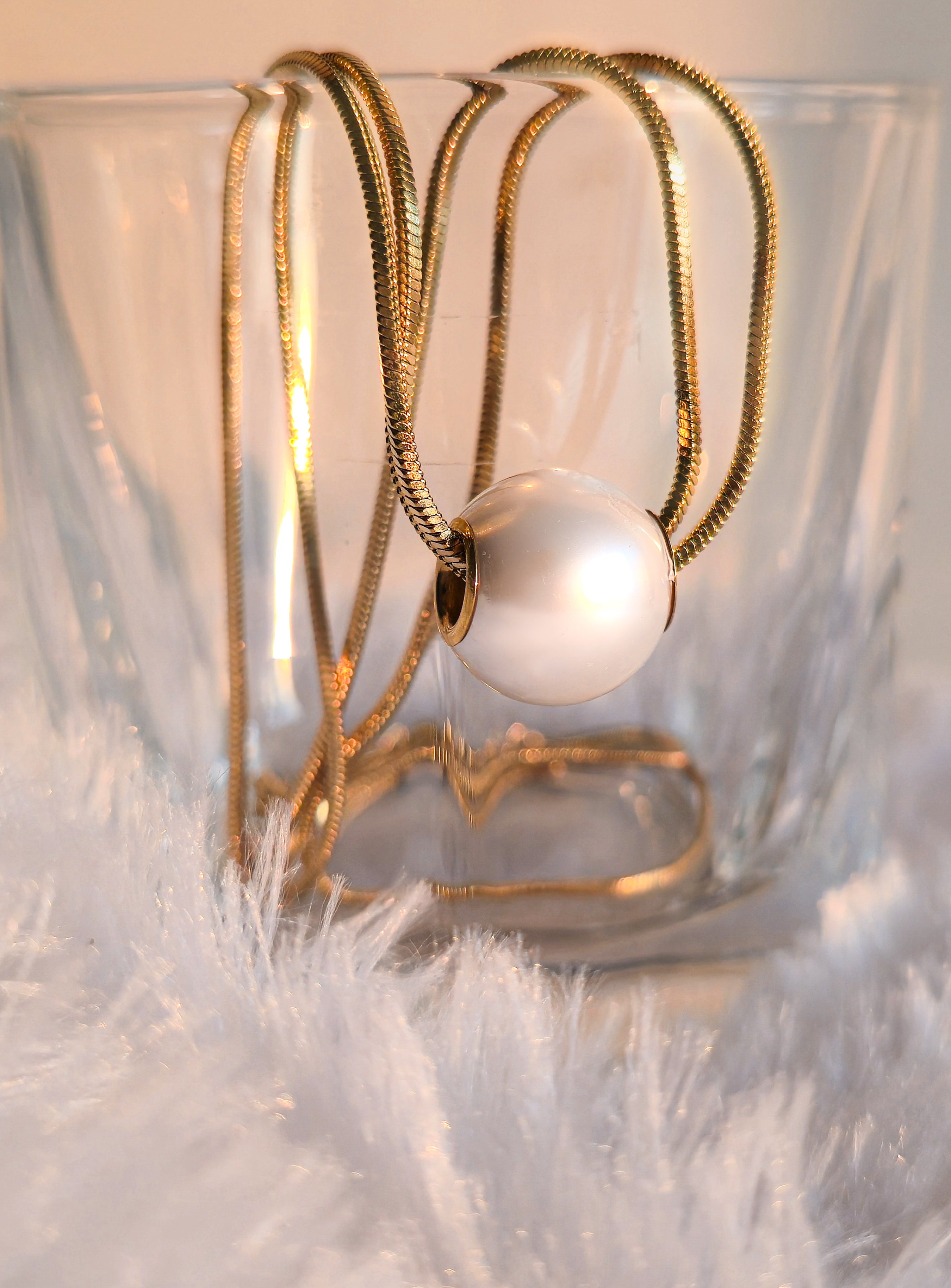 aurora pearl necklace on glass close up - coated with heavy gold stainless steel by rayona for women