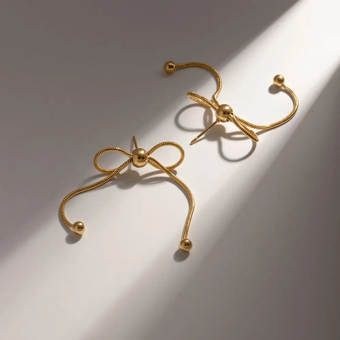 Close-up of Celestial Bow Earrings – dainty gold bow studs by Rayona