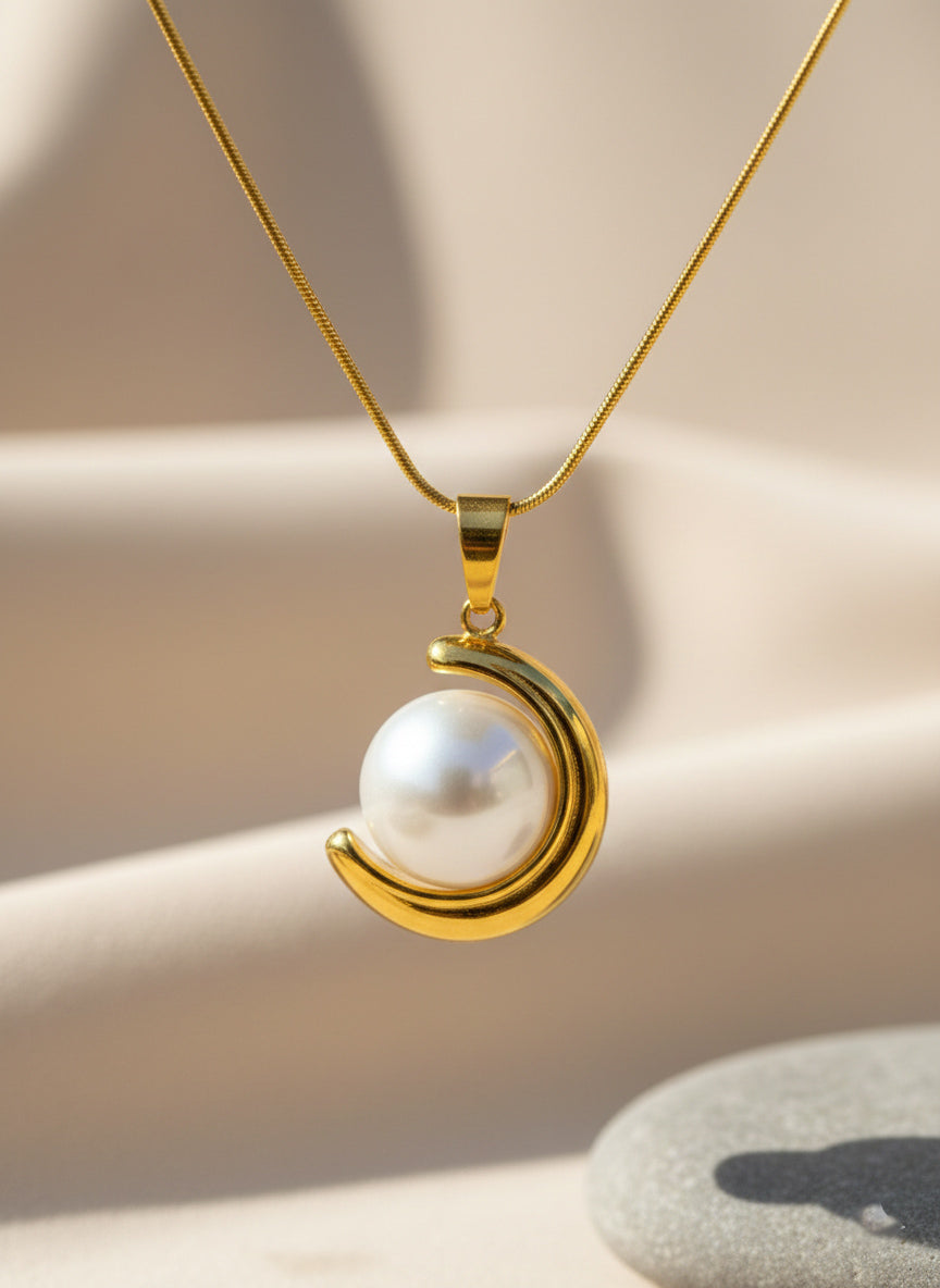 close up of crescent necklace styled in stainless steel