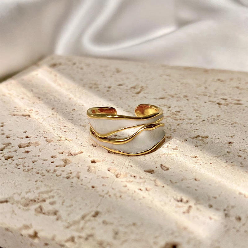 Ethereal Wave Ring flat lay – timeless minimal gold ring handcrafted by Rayona