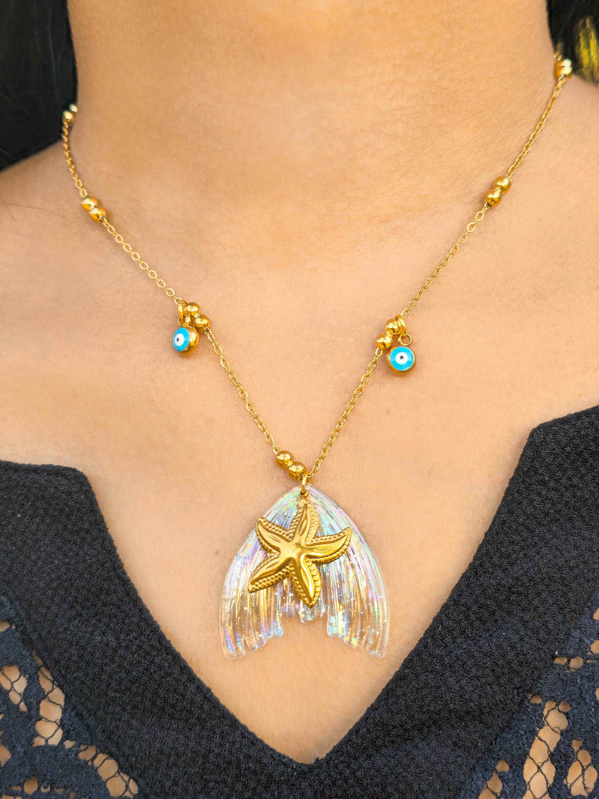 ocean Starfish gold pendant necklace with evil eye detail worn on neckline