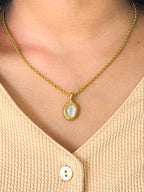 model wearing white stone necklace with pendant gold coated stainless steel by rayona