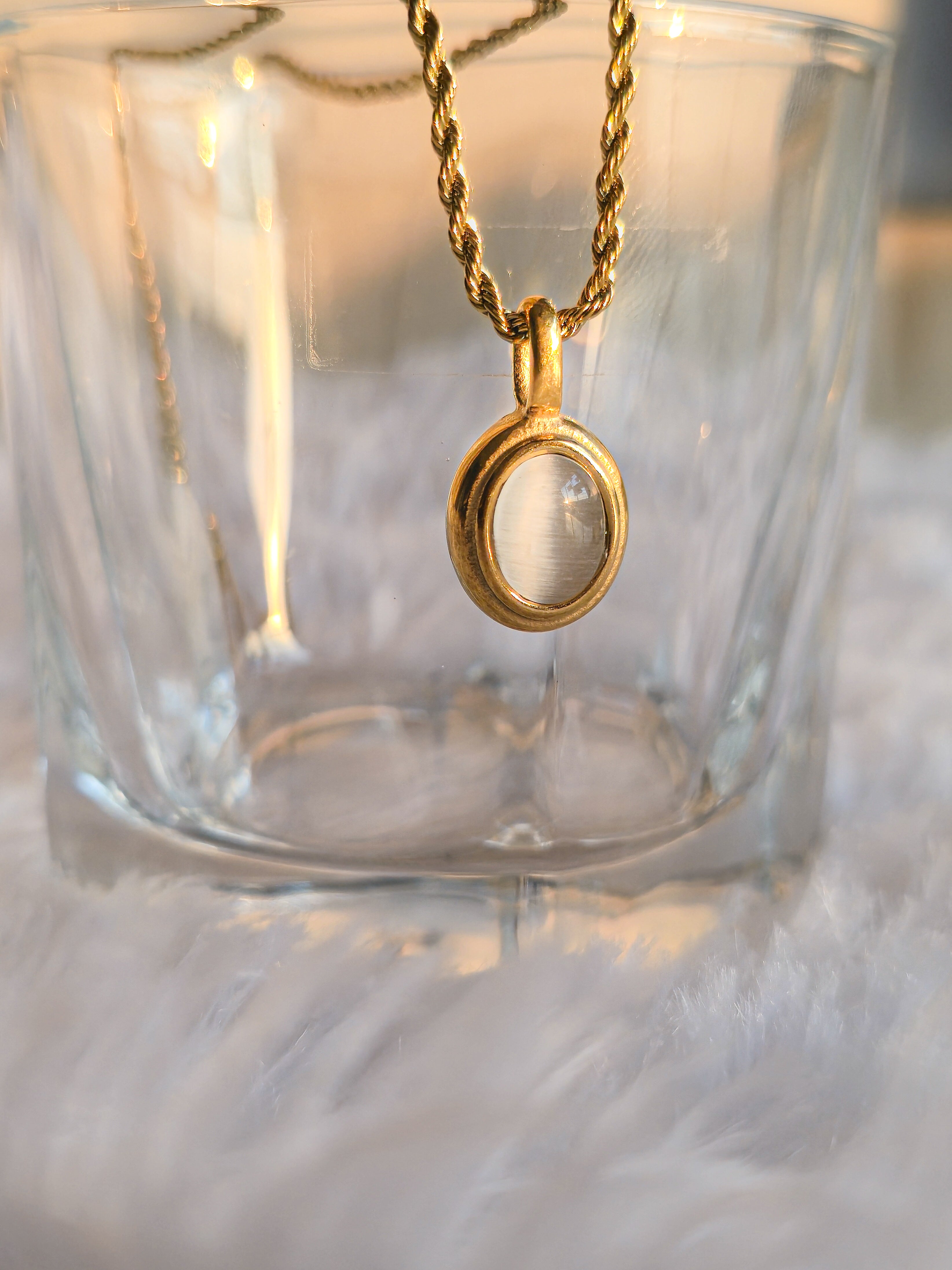 close up of white stone pendant necklace on glass by rayona jewelry india